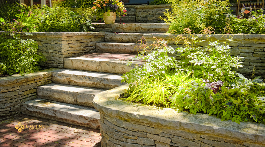 Retaining wall protecting elevated planting bed with trees and shrubs on a landscaped slope. 