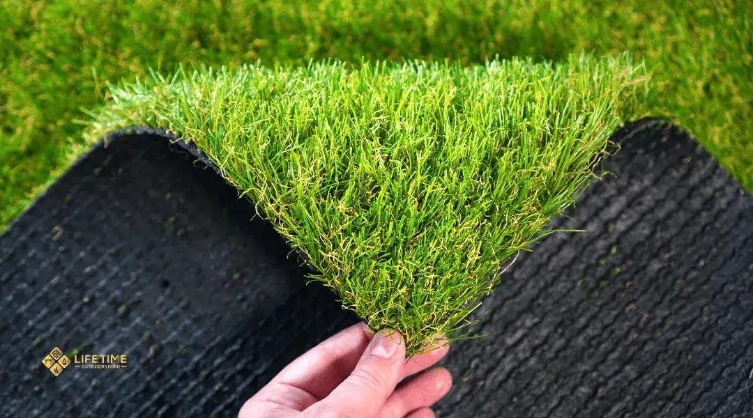 Artificial turf showing problems from poor securing: edges curling, bubbles under surface, seams separating, and water pooling at lifted corners.